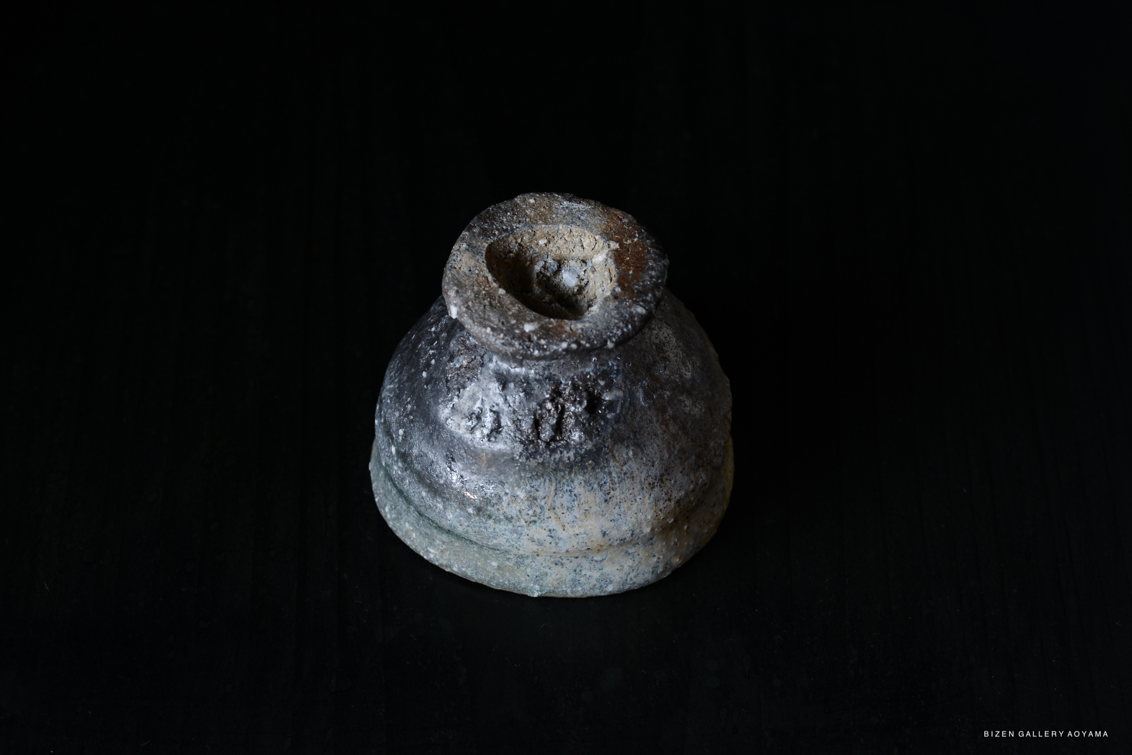 A top view of a traditional Iga pottery vessel featuring a textured, rustic surface and a narrow opening.
