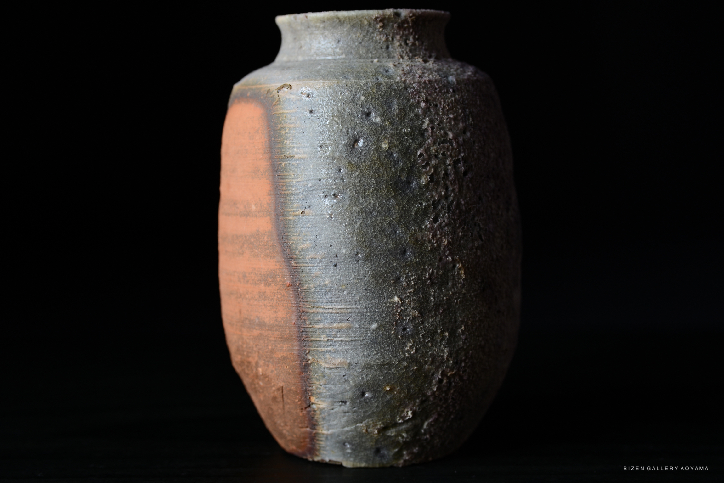 A close-up view of a Kotsubo (Chaire), a traditional Japanese tea caddy, showcasing its unique textured surface and distinct coloration.