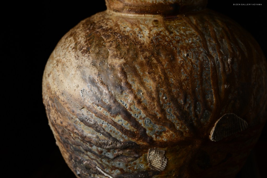 Close-up of a Bizen pottery vase showcasing unique texture and color variations.