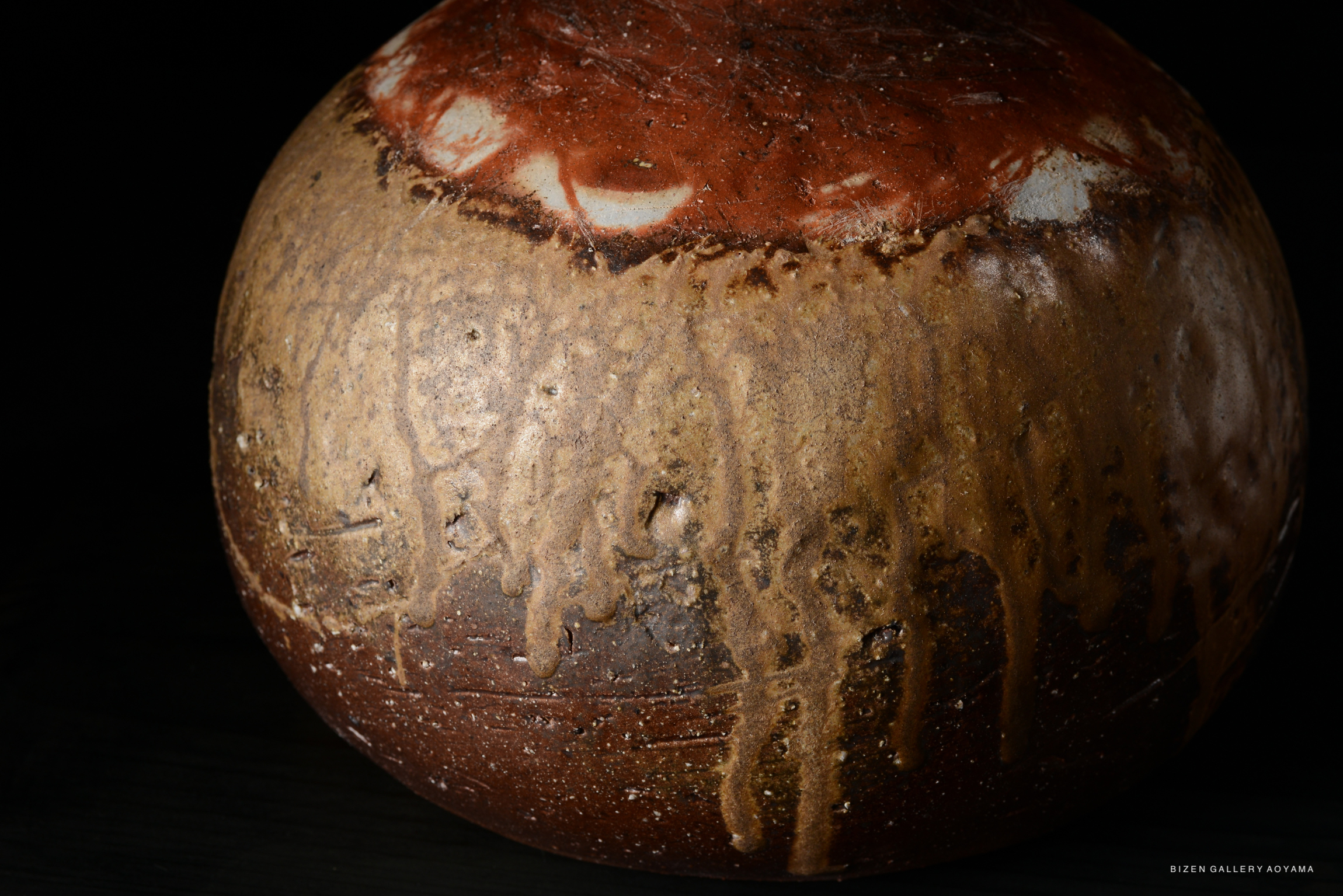 Close-up of a Bizen O Kabura Tokkuri, showcasing its unique clay texture and natural glaze patterns.