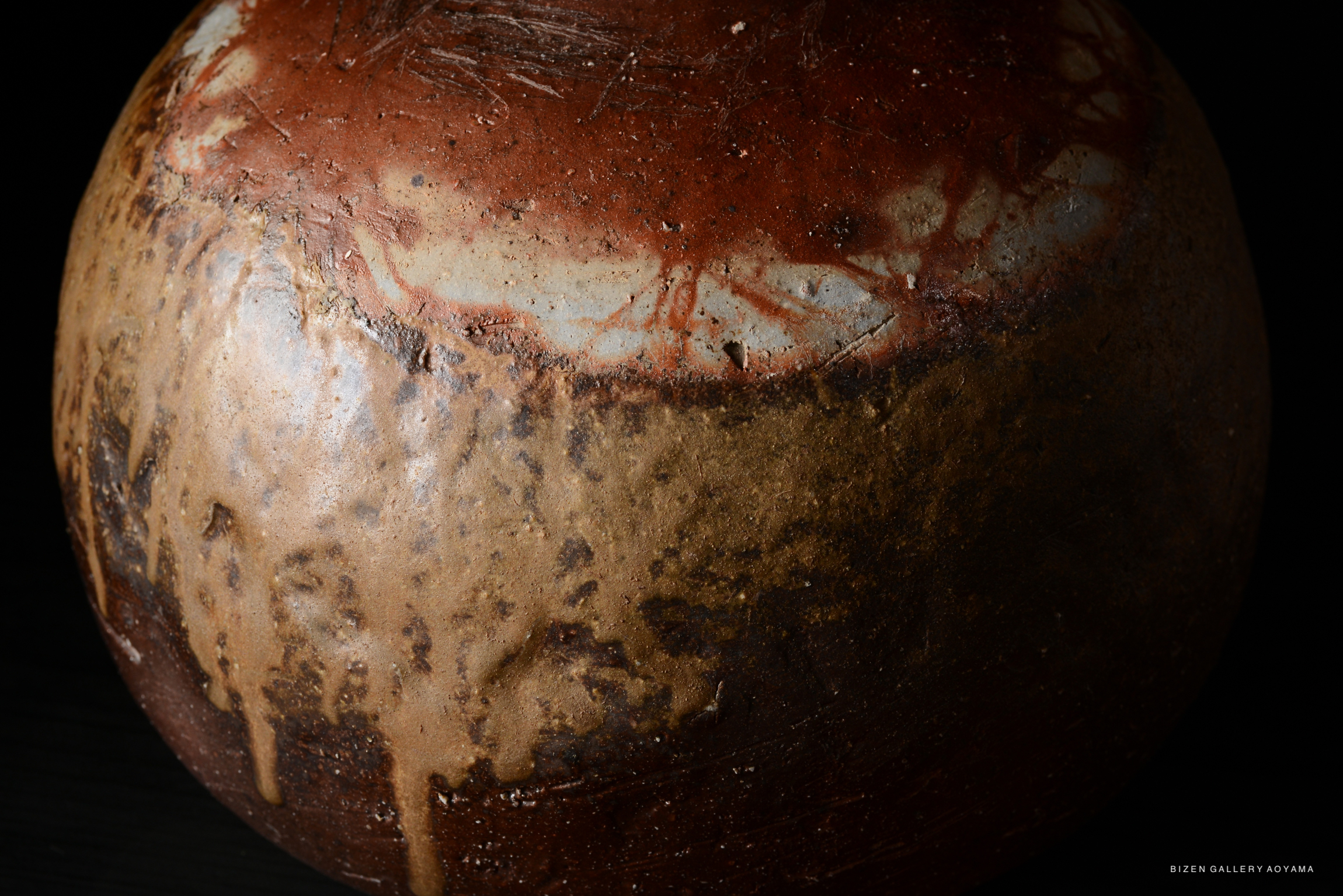 Close-up view of a Bizen O Kabura Tokkuri, showcasing its textured surface and unique glaze patterns.