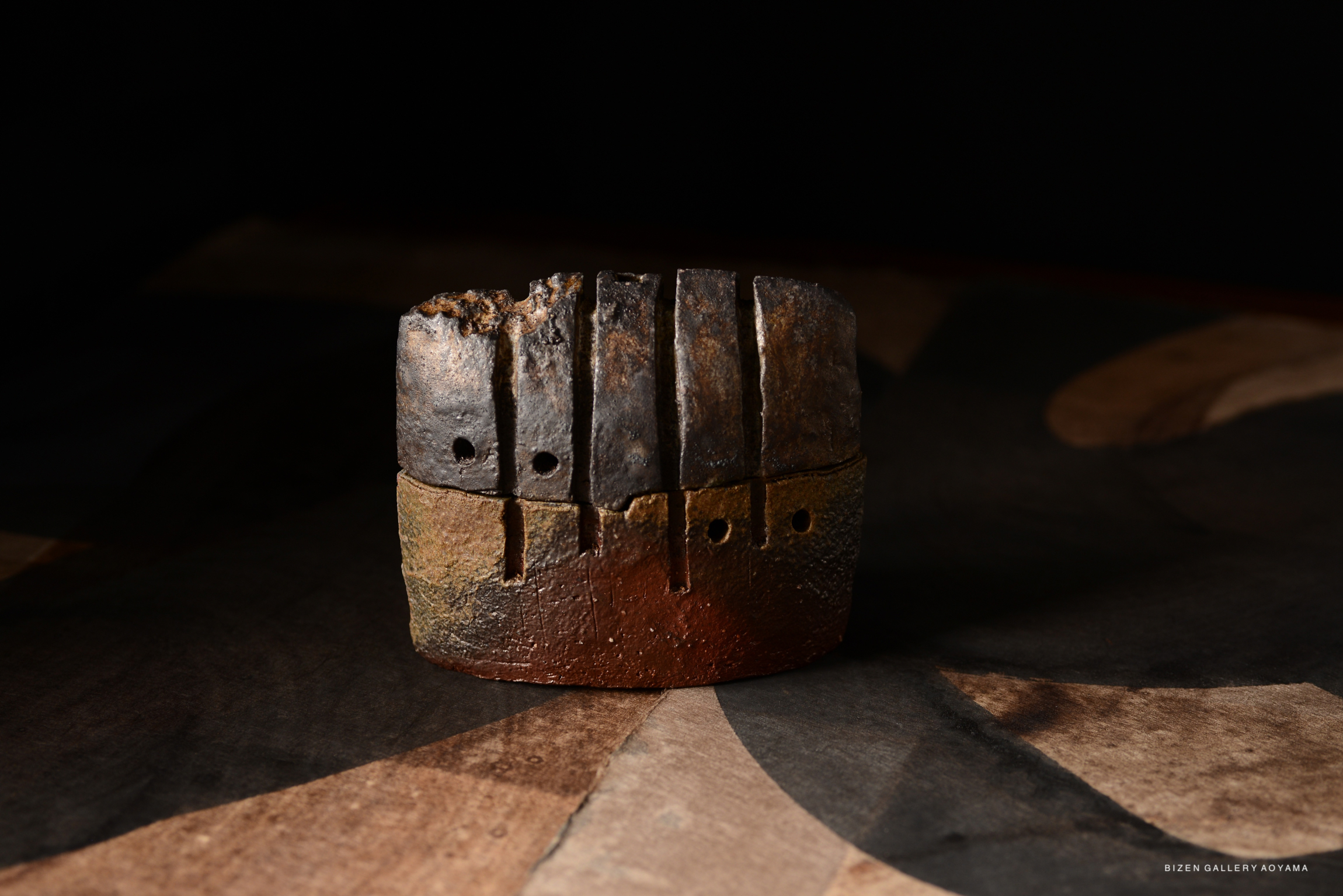 A traditional Japanese incense burner, crafted with a textured surface and earthy colors, showcasing artistic details and a rustic aesthetic.