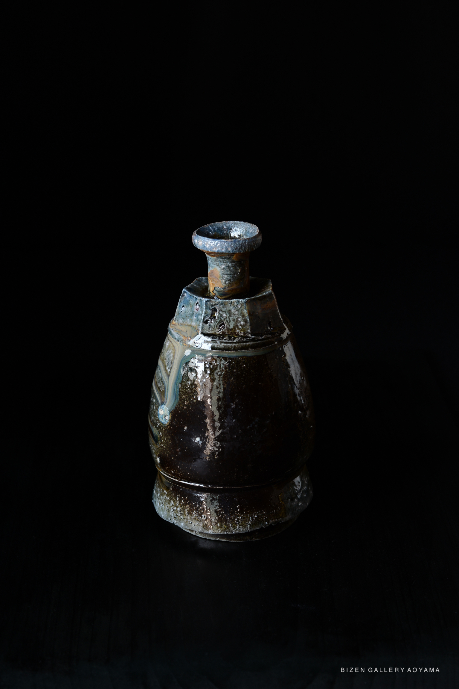 A Kuro Tokkuri, a traditional Japanese sake decanter, displayed against a black background.