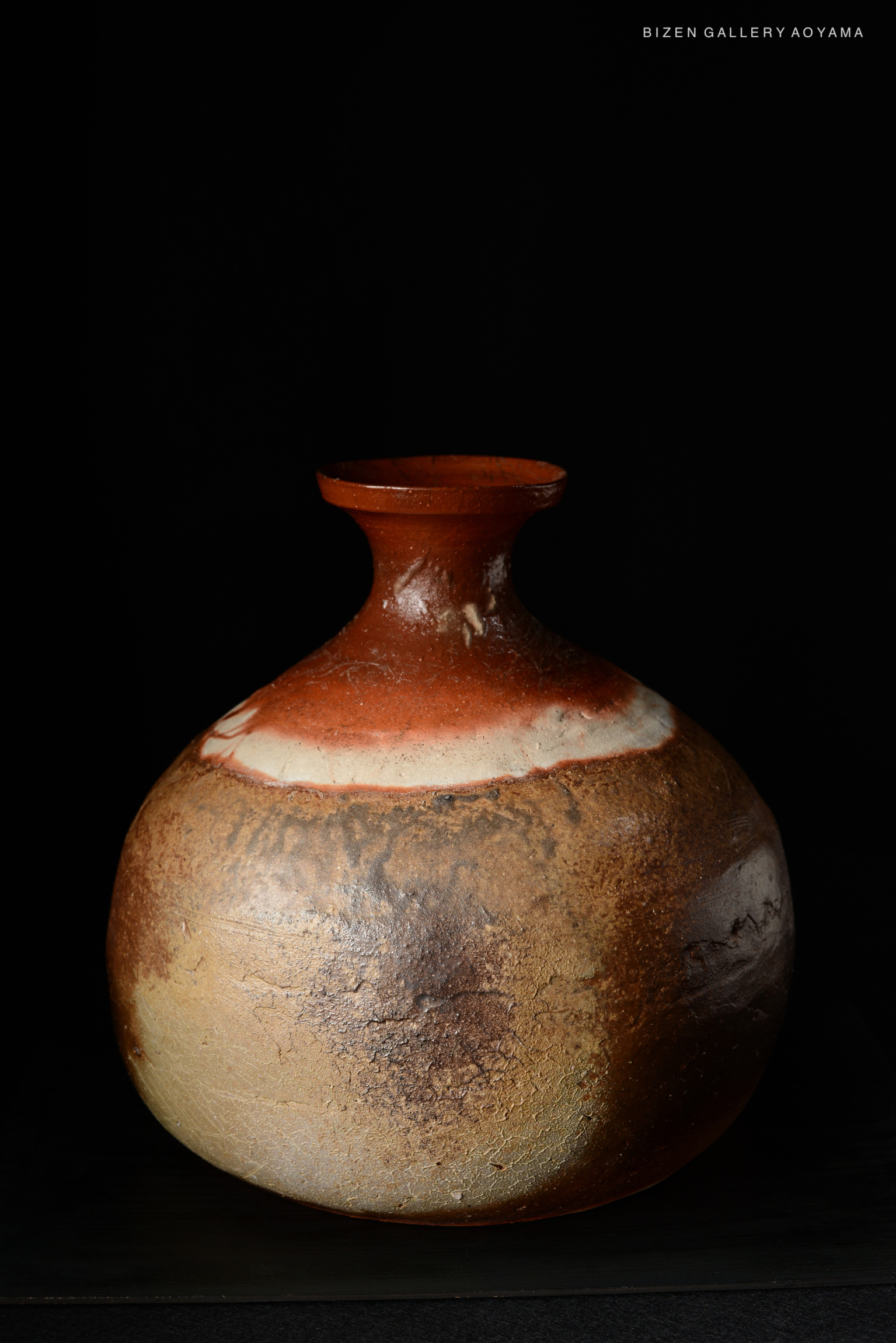 Bizen O Kabura Tokkuri, a traditional Japanese pottery vessel with a round body and narrow neck, featuring earthy tones and a textured surface.