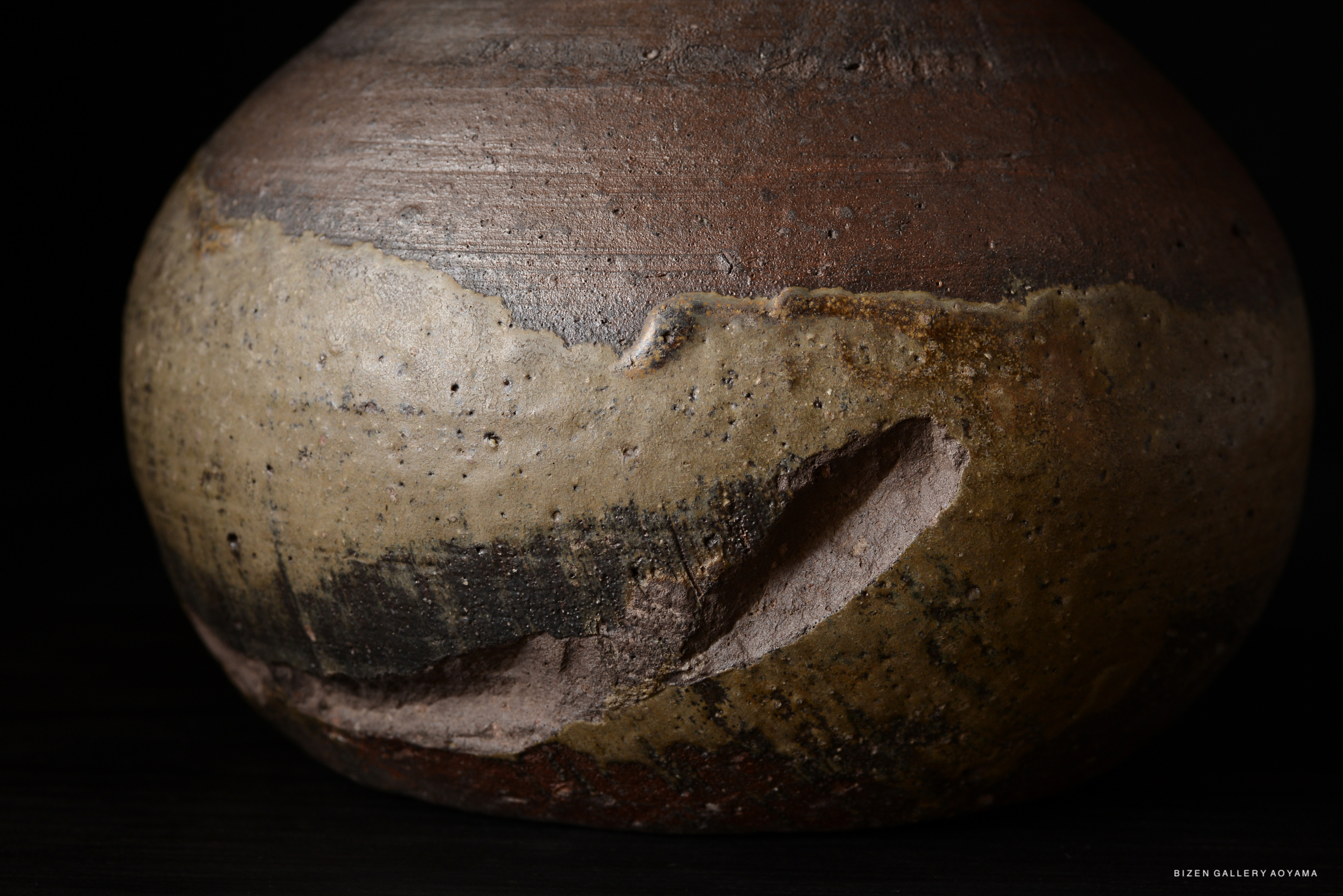 Close-up view of a textured ceramic pot with earthy colors, showcasing intricate surface details.