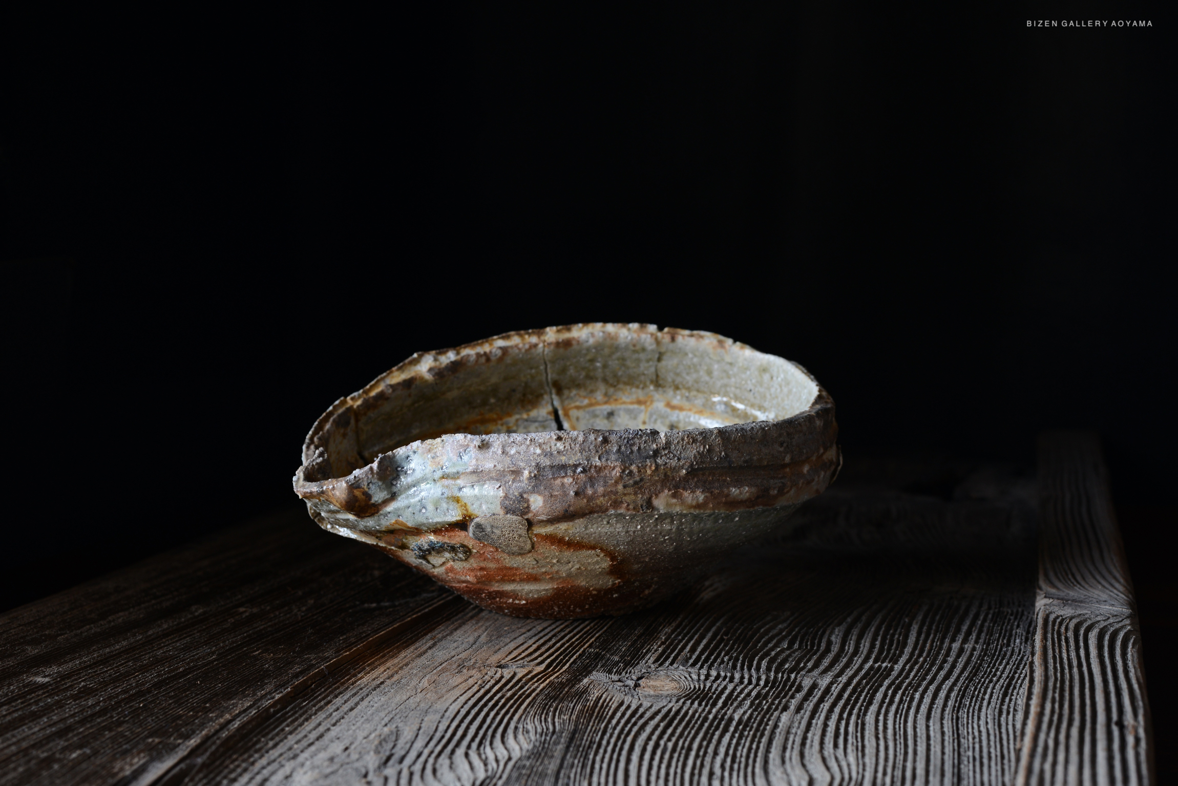 暗い背景の上に置かれた芸術的な形状の陶器の皿